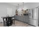 Charming kitchen features gray cabinetry, stainless steel appliances, and decorative floating shelves at 200 Mcclure Dr, Cumming, GA 30028
