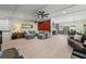 Open-concept living room with hardwood floors, a fireplace, and a seamless flow into the kitchen and dining area at 200 Mcclure Dr, Cumming, GA 30028
