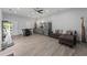 Open concept living room has hardwood floors, stainless steel refrigerator and modern furniture at 200 Mcclure Dr, Cumming, GA 30028