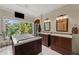 A luxurious main bathroom boasts dual wood vanities, soaking tub, and a lovely view at 200 Mcclure Dr, Cumming, GA 30028