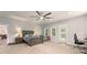 This primary bedroom suite features natural lighting, soft carpet and decorative ceiling fan at 200 Mcclure Dr, Cumming, GA 30028