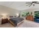 The main bedroom has hardwood floors, a ceiling fan, and several windows with tree and sky views at 200 Mcclure Dr, Cumming, GA 30028