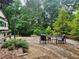 Relaxing stone patio with comfortable seating and beautiful landscaping creates a serene outdoor space at 200 Mcclure Dr, Cumming, GA 30028