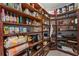 Walk-in pantry room with lots of wooden shelves and ample storage space for food and cooking equipment at 200 Mcclure Dr, Cumming, GA 30028
