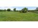 Sprawling green lawn with fencing and scattered trees at 200 Mcclure Dr, Cumming, GA 30028