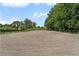Wide shot of horse riding arena showing level sand footing and perimeter fencing at 200 Mcclure Dr, Cumming, GA 30028
