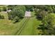 Spacious riding arena surrounded by green pastures and fencing at 200 Mcclure Dr, Cumming, GA 30028