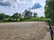 Spacious riding arena features ample space for training, with a backdrop of green hills and trees at 200 Mcclure Dr, Cumming, GA 30028