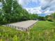 Picturesque riding arena with lush greenery, fencing and mature trees create a serene training space at 200 Mcclure Dr, Cumming, GA 30028