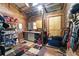 Organized tack room with storage shelves, cabinets, and a colorful rug at 200 Mcclure Dr, Cumming, GA 30028