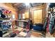 View of the tack room in the barn, complete with shelving, utility sink, small refrigerator and door at 200 Mcclure Dr, Cumming, GA 30028