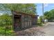 Small wood shed with a stack of firewood, a window, and doors next to a split rail fence at 200 Mcclure Dr, Cumming, GA 30028