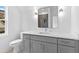 Bathroom featuring quartz counters, gray cabinetry, modern mirror, and vanity lighting at 208 Regester Way, Peachtree City, GA 30269