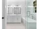 Modern bathroom featuring double sinks, vanity, soaking tub and walk-in shower at 208 Regester Way, Peachtree City, GA 30269