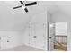 Bedroom with a modern ceiling fan, closet, paneled doors, and bright walls at 208 Regester Way, Peachtree City, GA 30269