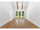 Bedroom with hardwood floors, high ceilings, beams, and french doors to backyard at 208 Regester Way, Peachtree City, GA 30269