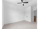 Bedroom with modern ceiling fan, neutral walls, closet, and doorway access to stairwell at 208 Regester Way, Peachtree City, GA 30269