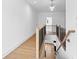 Upstairs hallway with wood railings and a view of the stairway at 208 Regester Way, Peachtree City, GA 30269