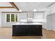 Modern kitchen featuring a center island with storage and lots of bright, white cabinets at 208 Regester Way, Peachtree City, GA 30269