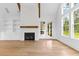 Bright living room with hardwood floors, fireplace, transom windows and wood beams at 208 Regester Way, Peachtree City, GA 30269