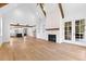 Spacious living room with kitchen view, fireplace, and hardwood floors at 208 Regester Way, Peachtree City, GA 30269