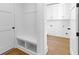 A well-organized mudroom with bench seating, storage, and access to the laundry room at 208 Regester Way, Peachtree City, GA 30269