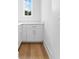 Bright pantry with white cabinets, quartz counters and hardwood floors at 208 Regester Way, Peachtree City, GA 30269