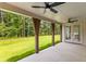 Covered patio showing ceiling fans, wooden beam supports and lush green backyard at 208 Regester Way, Peachtree City, GA 30269