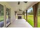 Covered patio features a ceiling fan, stone fireplace, and wooden beam supports at 208 Regester Way, Peachtree City, GA 30269