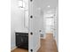 Stylish powder room featuring dark cabinetry and hardwood floors at 208 Regester Way, Peachtree City, GA 30269