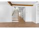 Entryway with hardwood floors and staircase with wooden banister and white risers at 208 Regester Way, Peachtree City, GA 30269