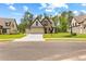 Charming homes with manicured lawns, stone accents, and modern garages with long driveways at 208 Regester Way, Peachtree City, GA 30269