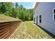 A spacious backyard featuring a wooden retaining wall with ample space for outdoor activities and relaxation at 354 Jada Ln, Villa Rica, GA 30180
