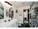 Modern bathroom with double vanity, elegant mirrors, and a luxurious glass-enclosed shower with marble accents at 354 Jada Ln, Villa Rica, GA 30180