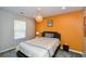 Bedroom with grey carpet, off-white walls, and a striking orange accent wall at 354 Jada Ln, Villa Rica, GA 30180