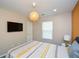 Bedroom features carpet, off-white walls, TV, and a unique wicker pendant light at 354 Jada Ln, Villa Rica, GA 30180