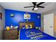 Bedroom featuring blue and gray walls, ceiling fan, and Golden State Warriors decor at 354 Jada Ln, Villa Rica, GA 30180