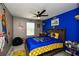 Golden State Warriors-themed bedroom with bold blue accent wall and ceiling fan at 354 Jada Ln, Villa Rica, GA 30180