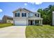 Charming two-story home with a covered front porch, attached garage and well-manicured lawn at 354 Jada Ln, Villa Rica, GA 30180