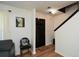 Bright foyer with hardwood floors, a black door, and staircase featuring black trim at 354 Jada Ln, Villa Rica, GA 30180