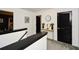 Upstairs hallway featuring stylish black doors, white walls, and a modern console table with decorative accents at 354 Jada Ln, Villa Rica, GA 30180