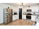 Bright kitchen featuring white cabinets, stainless steel appliances, and hardwood floors at 354 Jada Ln, Villa Rica, GA 30180