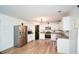 Bright kitchen featuring white cabinets, stainless steel appliances, and hardwood floors at 354 Jada Ln, Villa Rica, GA 30180