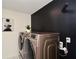 Modern laundry room with front-loading washer and dryer and stylish wall decor at 354 Jada Ln, Villa Rica, GA 30180