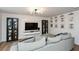 Cozy living room with a sectional sofa, stylish shelving, and bright decor at 354 Jada Ln, Villa Rica, GA 30180