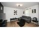 Cozy living room with laminate flooring, a gray sectional, and gaming chairs, ideal for relaxing at 354 Jada Ln, Villa Rica, GA 30180