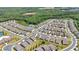 Aerial view of the community with rows of homes, landscaping, and green spaces nestled among the trees at 427 Bluffs View Ln, Canton, GA 30114