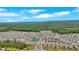 A high-angle aerial view shows the community with homes, landscaping, and green spaces surrounding the neighborhood at 427 Bluffs View Ln, Canton, GA 30114