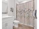Bathroom featuring white cabinets, a tile floor, and a shower with tub at 427 Bluffs View Ln, Canton, GA 30114