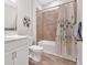 Bathroom featuring white cabinets, a tile floor, and a shower with tub at 427 Bluffs View Ln, Canton, GA 30114